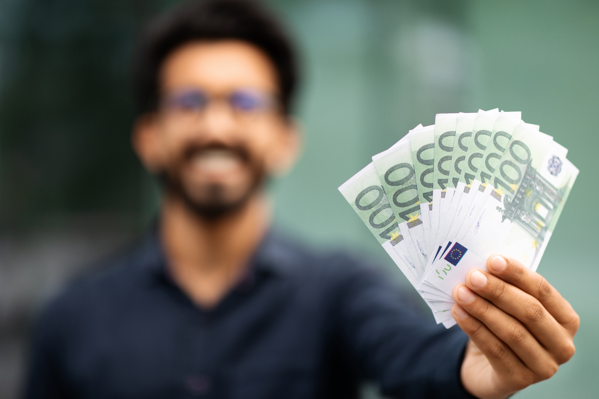 Cash money euro banknotes in middle eastern businessman hand